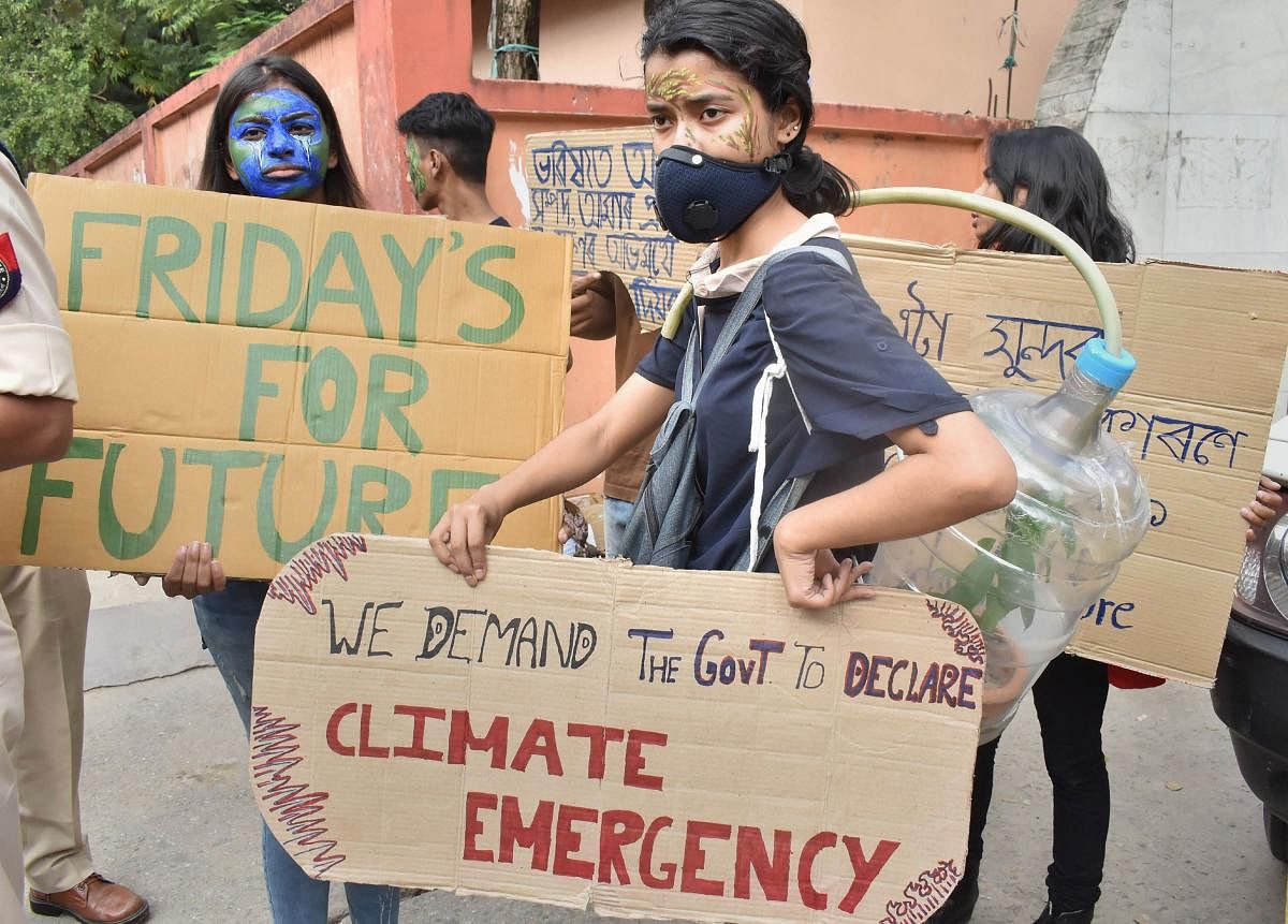 Youths hold placards during climate change protests which is a worldwide movement dubbed as 'Fridays for Future', in Guwahati, Friday, Nov. 8, 2019. (PTI Photo)