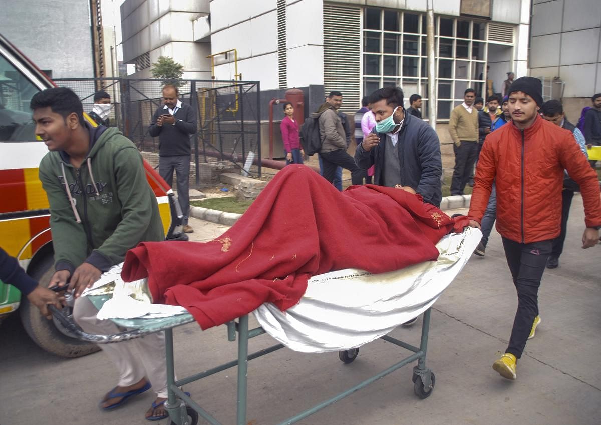 Patients being evacuated from an ESIC hospital, where a fire broke out, in Noida (PTI Photo)