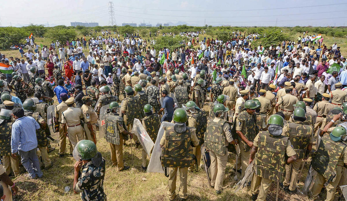 Police stop farmers arriving from various villagers to lay siege the Assembly in protest against the three-capital proposal for state of Andhra Pradesh, at Velagapudi in Guntur district, Monday, Jan. 20, 2020. (PTI Photo)