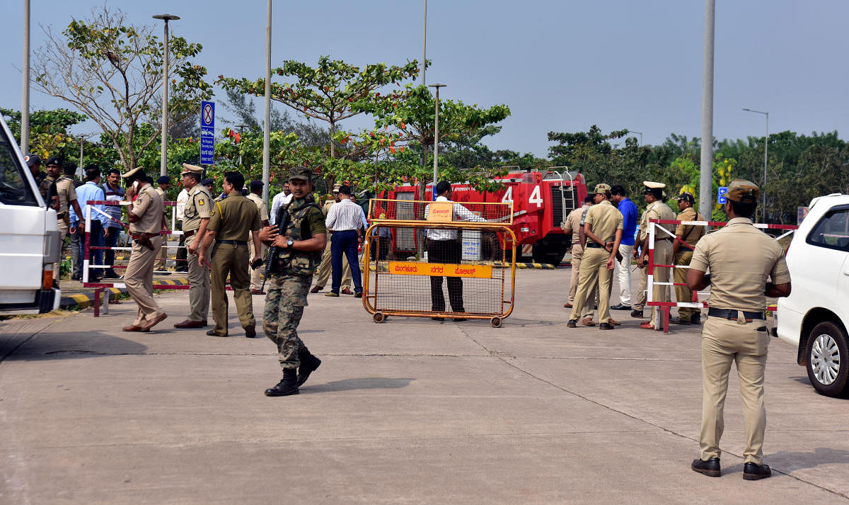 Police officials and staff seen with the dog squad and the bomb detection and disposal squad at the Mangalore International Airport on Monday.