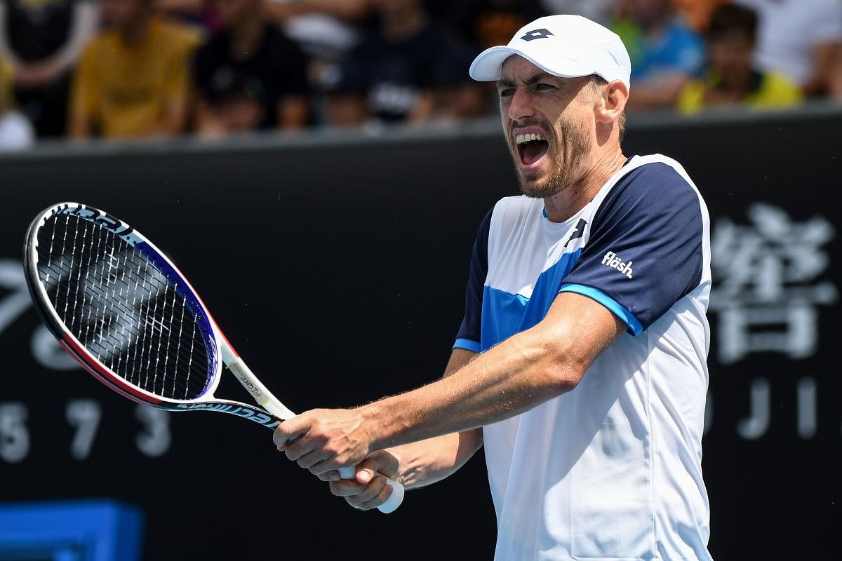 Australia's John Millman reacts after a point against France's Ugo Humbert during their men's singles match on day two of the Australian Open tennis tournament in Melbourne on January 21, 2020. (AFP Photo)