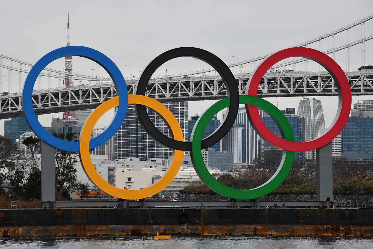 A large size Olympic Symbol is brought by a salvage barge to install at Tokyo Waterfront, in the waters of Odaiba Marine Park. (AFP Photo)