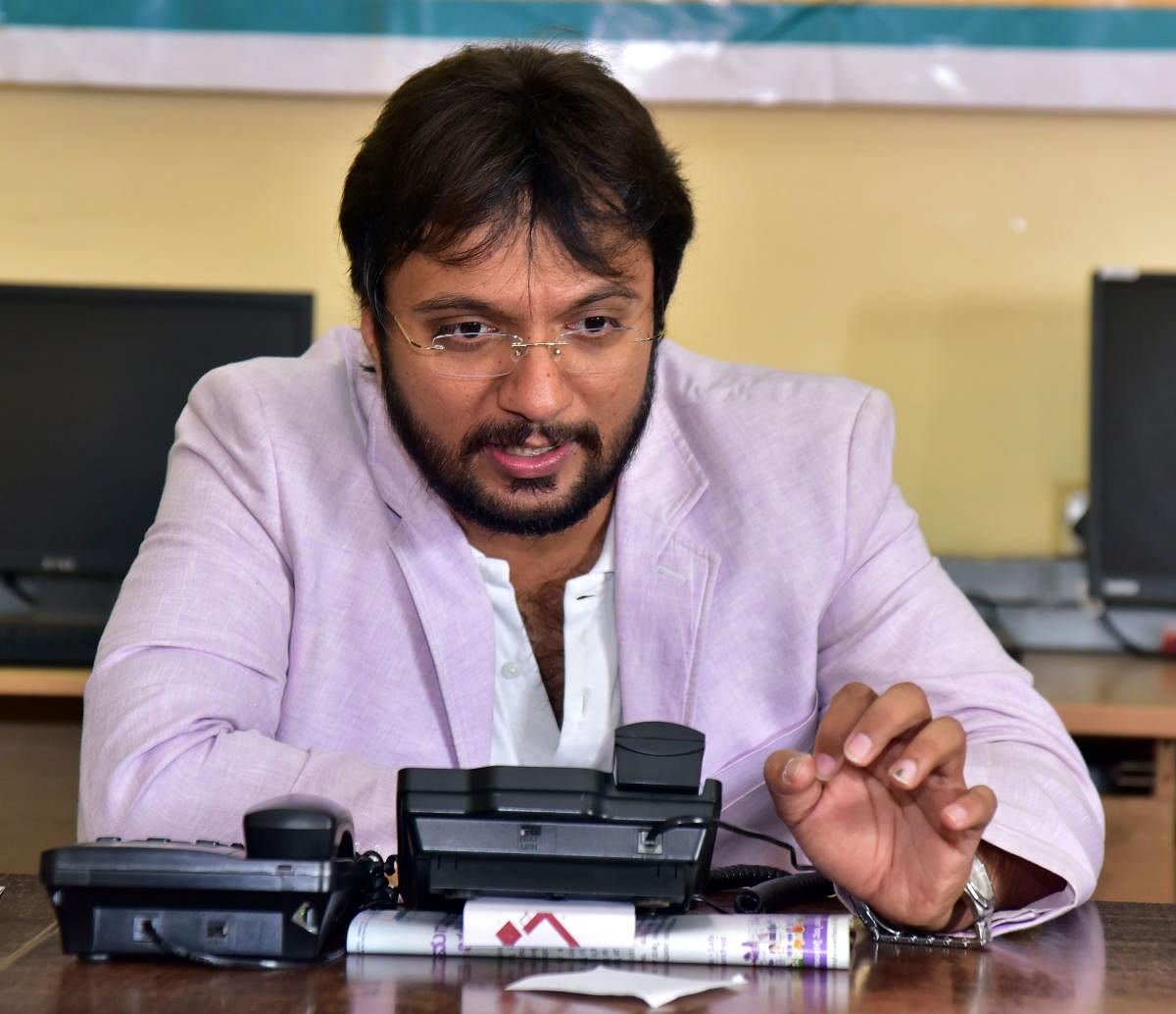 Dr Ananth Prabhu G, cyber security expert and professor at Sahyadri College of Engineering and Management, answers a call during the phone-in programme, organised by Prajavani, at DH-PV Editorial Office in Balmatta on Tuesday. DH photo