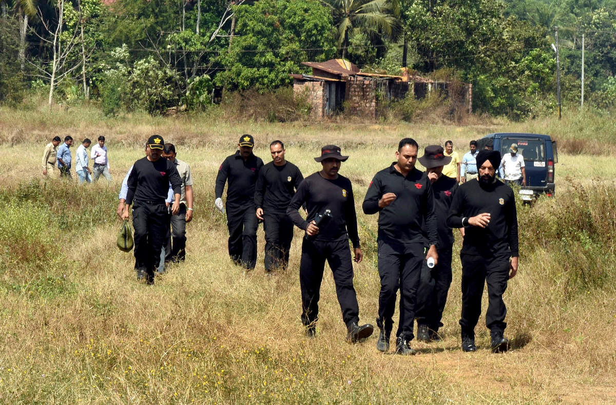 The members of Special Protection Group inspect the location on Tuesday where the explosive was detonated at Kenjar in Mangaluru. DH Photo