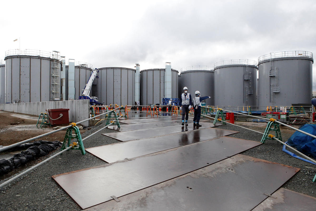 Workers are seen near storage tanks for radioactive water at tsunami-crippled Fukushima Daiichi nuclear power plant in Okuma town, Fukushima prefecture, Japan. Reuters