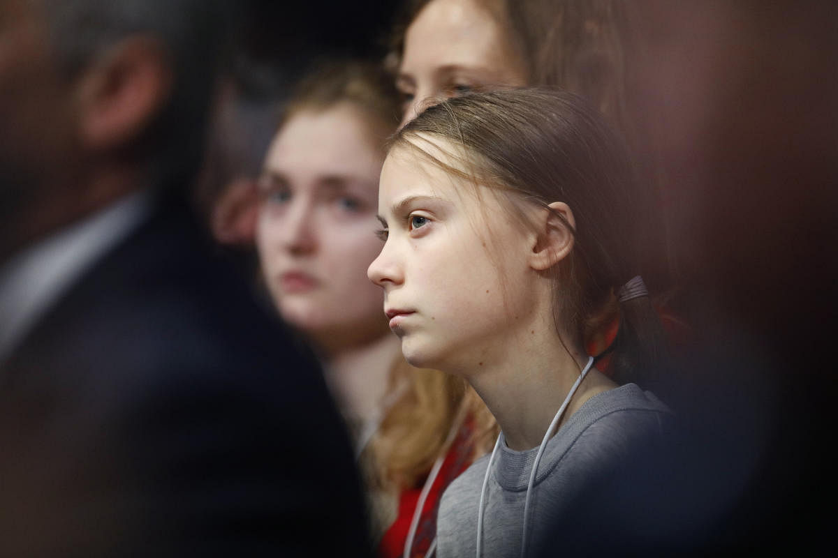 Swedish environmental activist Greta Thunberg listens as U.S. President Donald Trump addresses the World Economic Forum in Davos, Switzerland, Tuesday, Jan. 21, 2020. The 50th annual meeting of the forum will take place in Davos from Jan. 21 until Jan. 24, 2020. AP/PTI