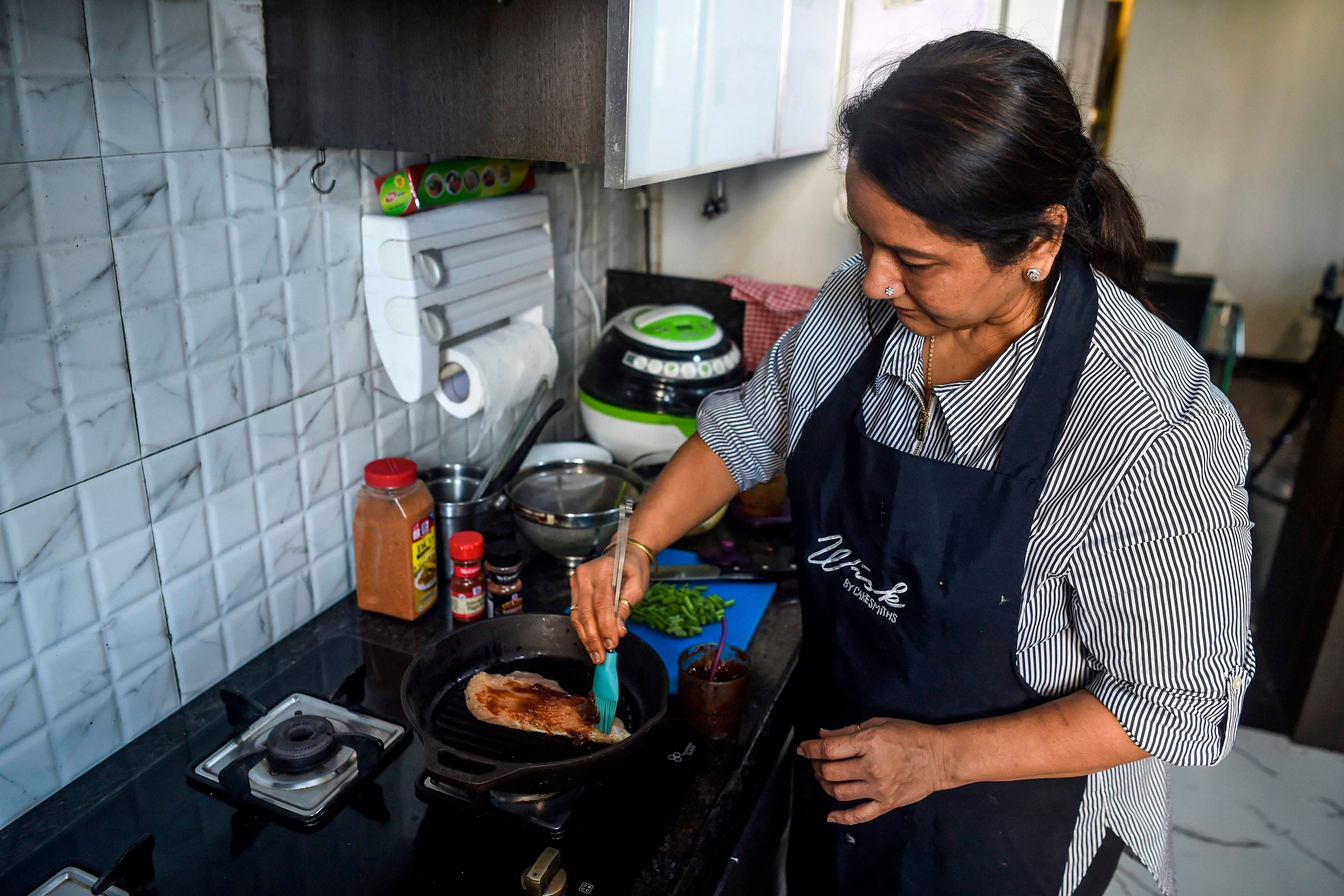 Rashmi Sahijwala never expected to start working at the age of 59, let alone join India's gig economy -- now she is part of an army of housewives turning their homes into "cloud kitchens" to feed time-starved millennials.. (AFP Photo)