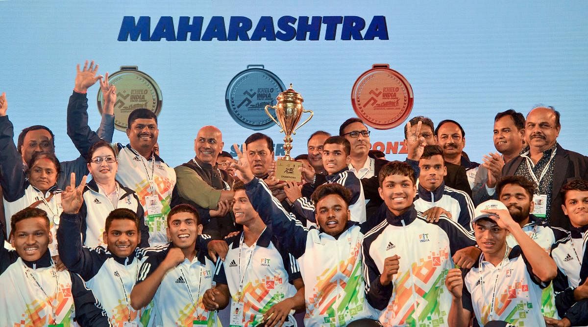Assam Chief Minister Sarbananda Sonowal with State Finance Minister Himanta Biswa Sarma hands over champion's trophy to Maharashtra during the closing ceremony of the Third Edition of Khelo India Youth Games 2020. (PTI Photo)