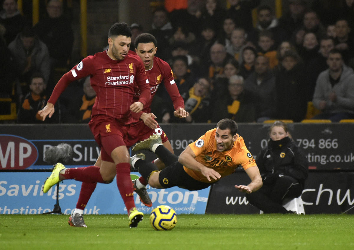 Liverpool's Alex Oxlade-Chamberlain, left, duels for the ball with Wolverhampton Wanderers' Jonny during the English Premier League match between Wolverhampton Wanderers and Liverpool. (AP Photo)
