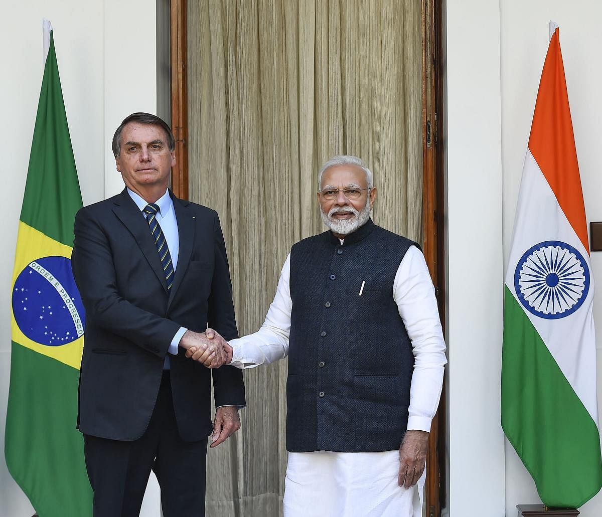 Prime Minister Narendra Modi shakes hands with Brazil's President Jair Messias Bolsonaro prior to a meeting at the Hyderabad House, in New Delhi, Saturday, Jan. 25, 2020. (PTI photo)