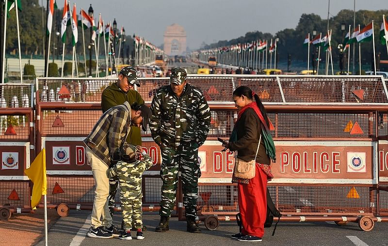 A child, donned in army uniform, interacts with security personnel standing guard at the Rajpath, which is all-set for the Republic Day Parade, in New Delhi, Saturday, Jan. 25, 2020. India is celebrating its 71st Republic Day this year. (PTI Photo)