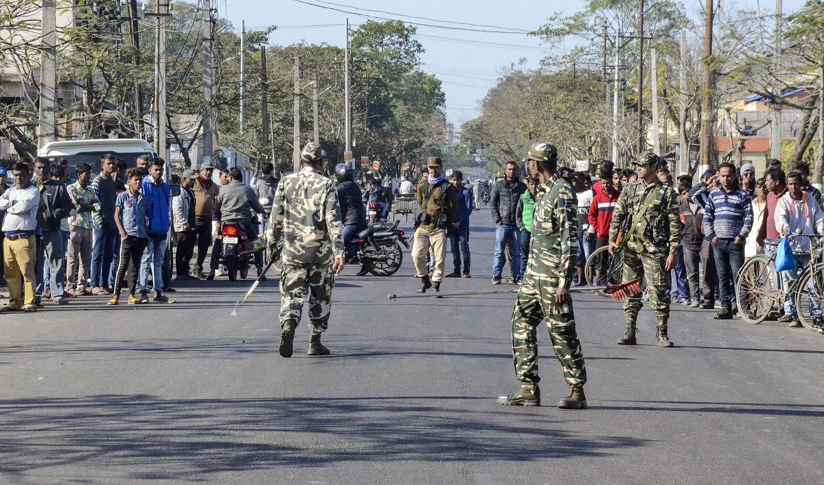Security forces personnel cordon off the site of blasts which took place at a garbage dumping area at Graham Bazar, in Dibrugarh. (PTI Photo)
