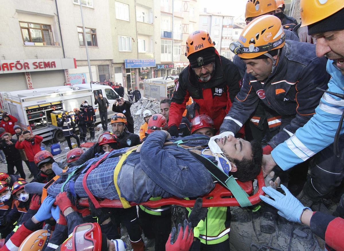 Rescue workers carry a wounded man that was found alive in the rubble of a building destroyed on Friday's earthquake in Elazig, eastern Turkey, Saturday, Jan. 25, 2020. (AP Photo)