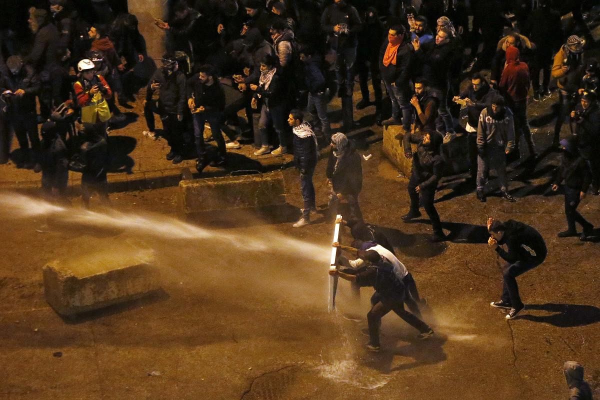 Riot police sprayed anti-government protesters with water cannons as they try to cross to the central government building during ongoing protests in Beirut, Lebanon, Saturday, Jan. 25, 2020. (AP Photo)