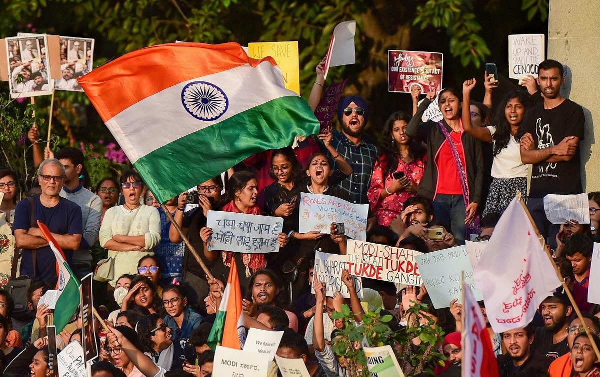 Protesters display placard and raise slogans during a rally against the Citizenship Amendment Act (CAA), National Register of Citizenship (NRC), National Population Register(NPR) and attack on JNU students, in Bengaluru, Monday, Jan. 6, 2020. (PTI Photo)