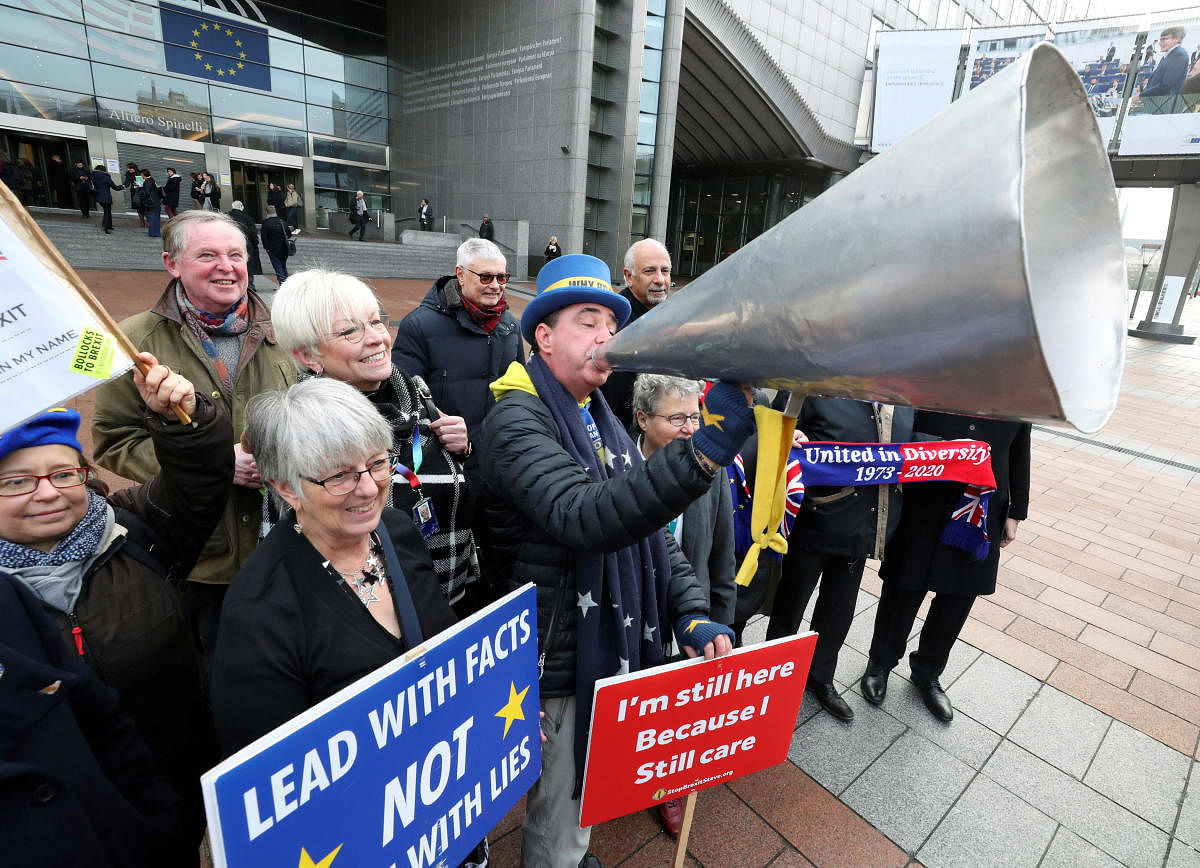 Westminster protester and anti-Brexit activist Steve Bray and members of the European Parliament take part in a protest outside the EU Parliament in Brussels. (Credit: Reuters Photo)