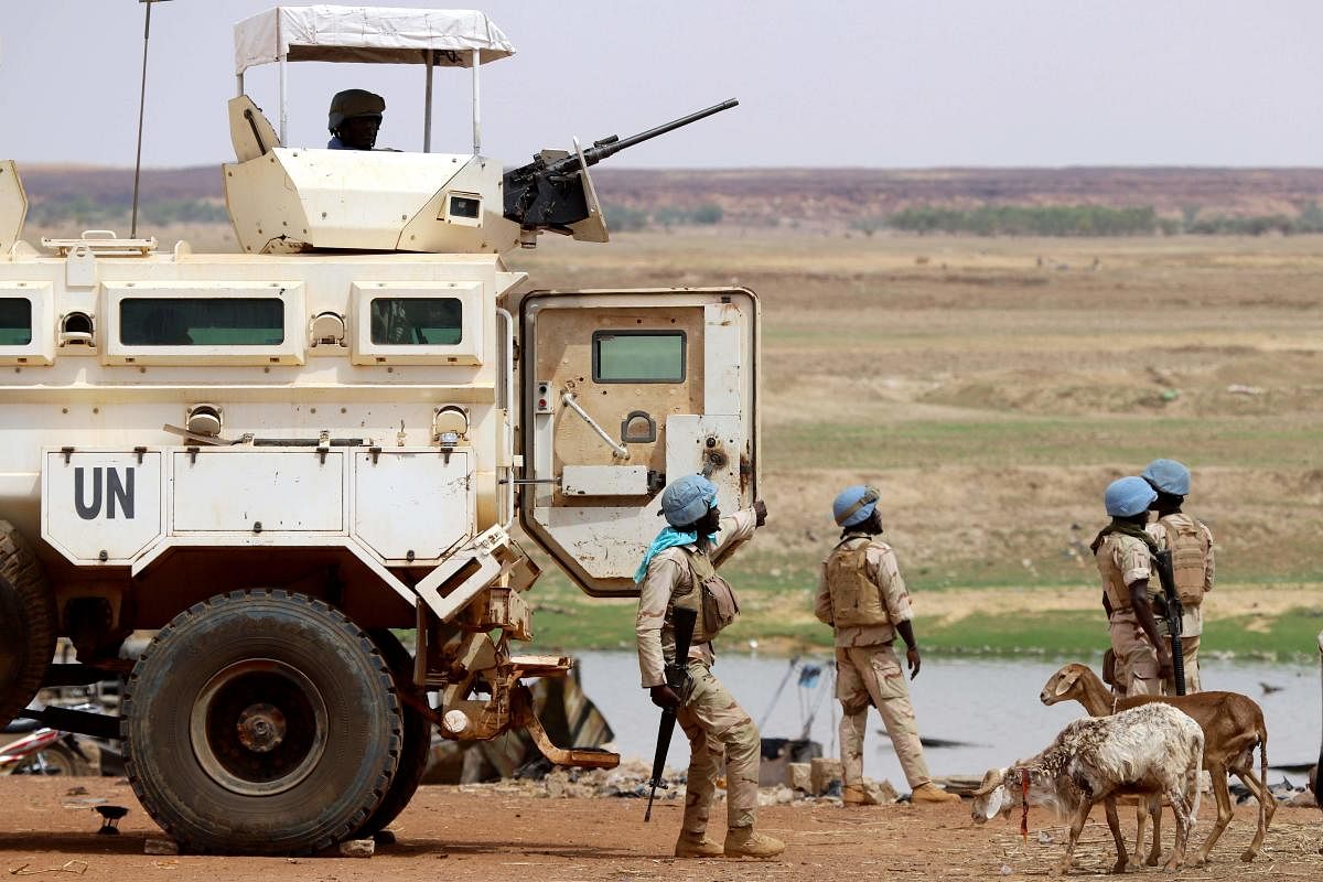 In this file photo taken on July 24, 2019 Senegalese soldiers the UN peacekeeping mission in Mali MINUSMA (United Nations Multidimensional Integrated Stabilisation Mission in Mali) dismount an armoured personnel carrier, patrolling in the streets of Gao,