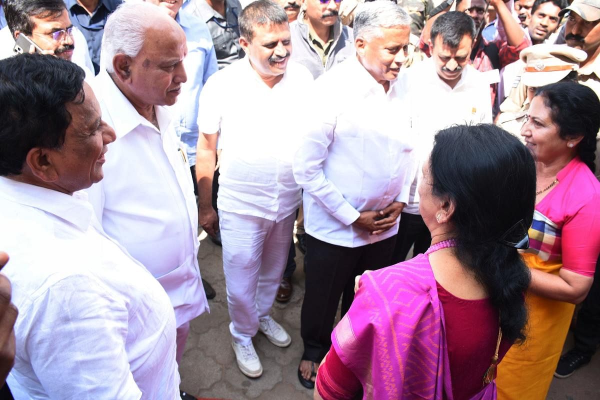 Chief Minister B S Yediyurappa speaks to MLC Veena Acchaiah and expresses his regrets over the violation of protocol during the foundation stone laying programme in the premises of government maternity hospital in Madikeri on Monday. DH Photo