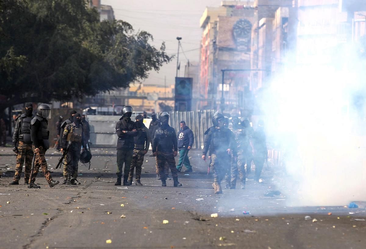 Iraqi security forces clash with protesters during anti-government demonstrations in al-Khillani Square off central Baghdad's Sinak bridge which links the Iraqi capital's Green Zone with the rest of the city on January 28, 2020