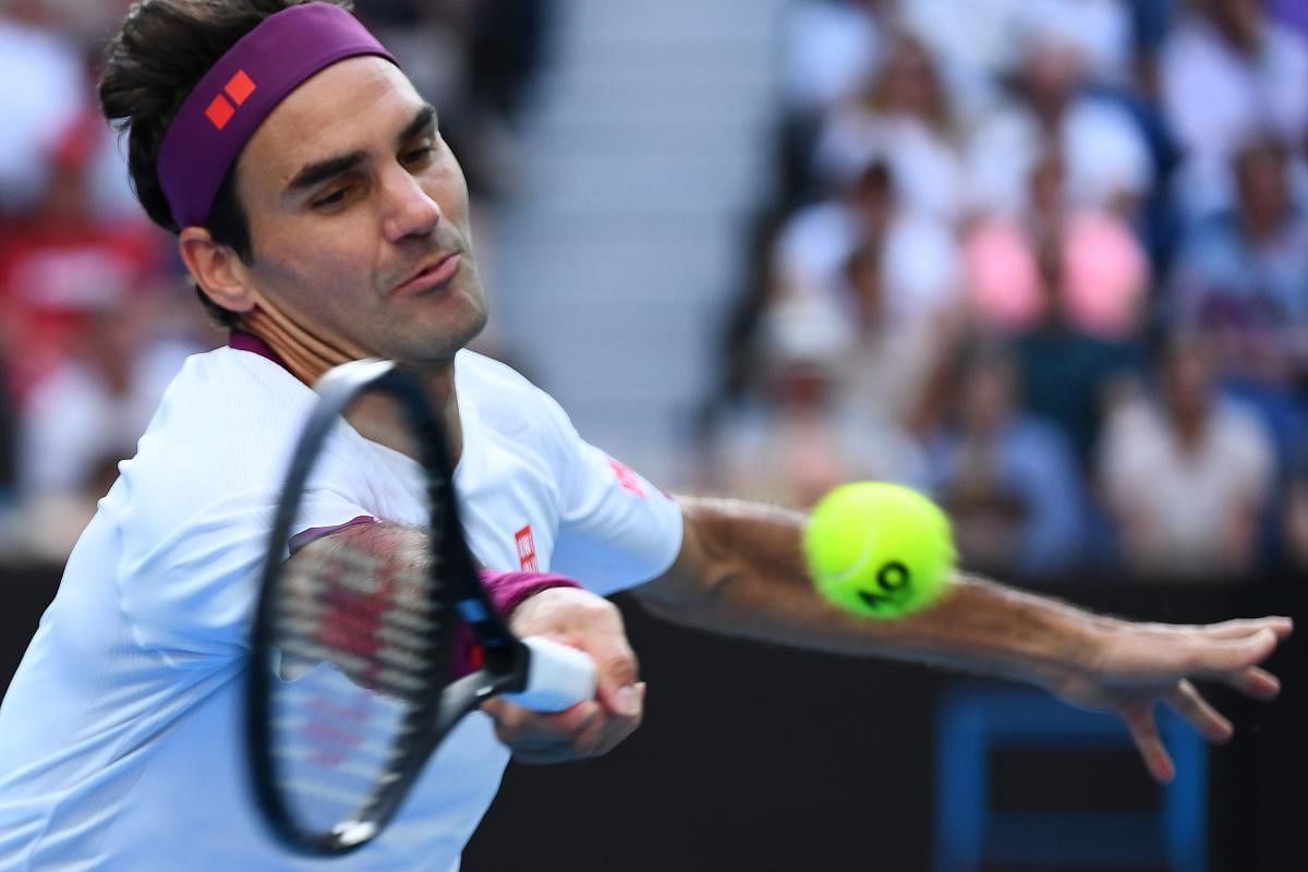 Switzerland's Roger Federer hits a return against Tennys Sandgren of the US during their men's singles quarter-final match on day nine of the Australian Open tennis tournament in Melbourne. AFP