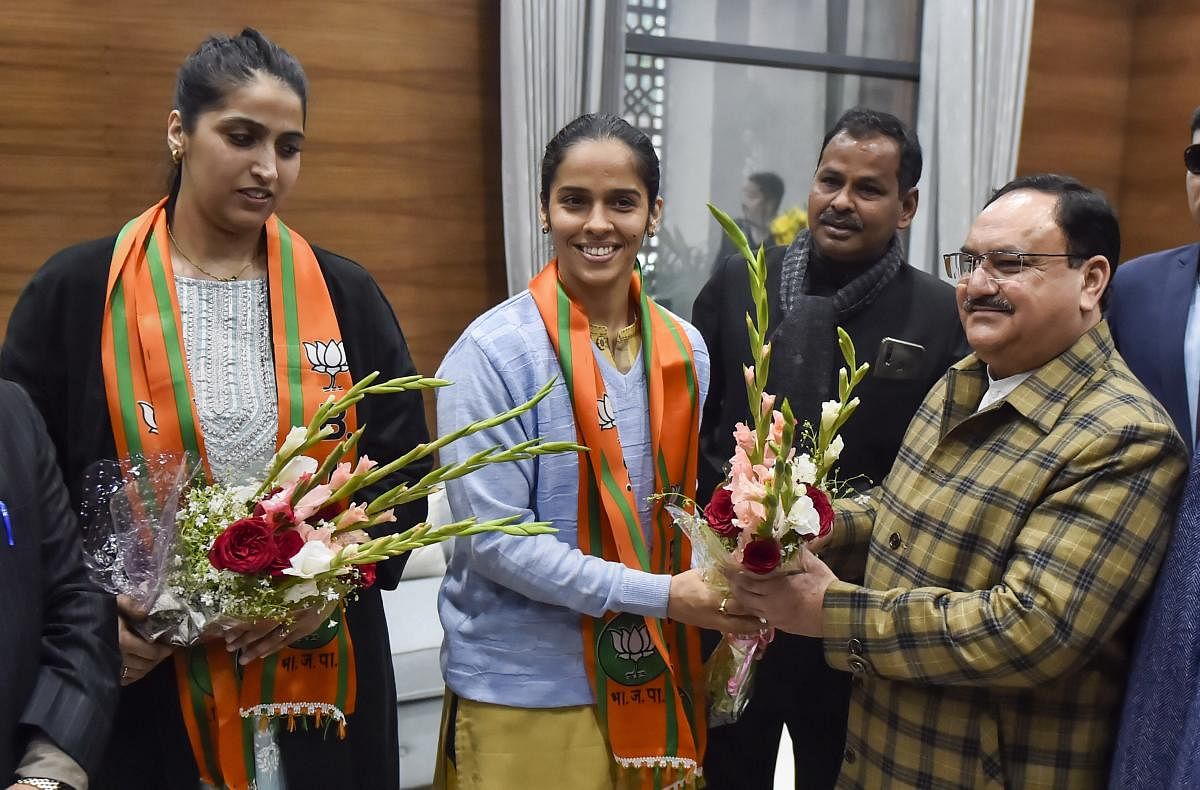 Badminton player Saina Nehwal and her sister Abu Chandranshu Nehwal (L) meet BJP President J P Nadda (R) after they joined Bharatiya Janata Party, in New Delhi. (PTI Photo)