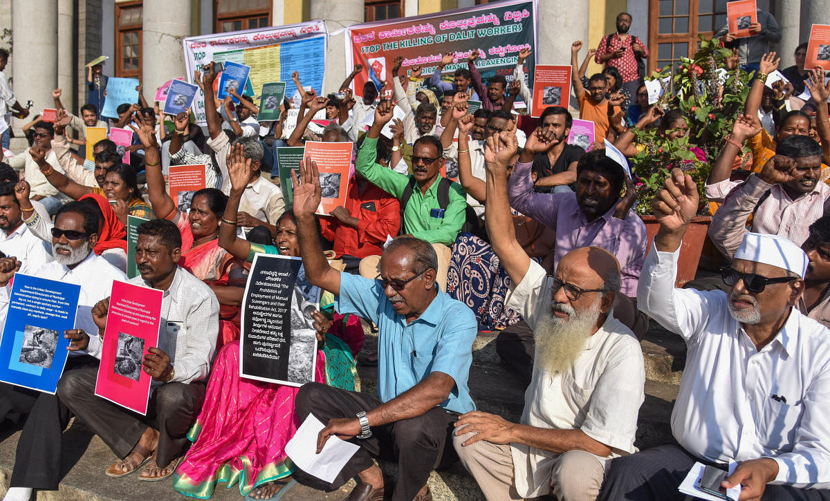 Members of various organisations participated in a protest at Town Hall on Monday, demanding justice for Sidappa’s family and asking the government to implement the law against manual scavenging. dh photo by S K Dinesh