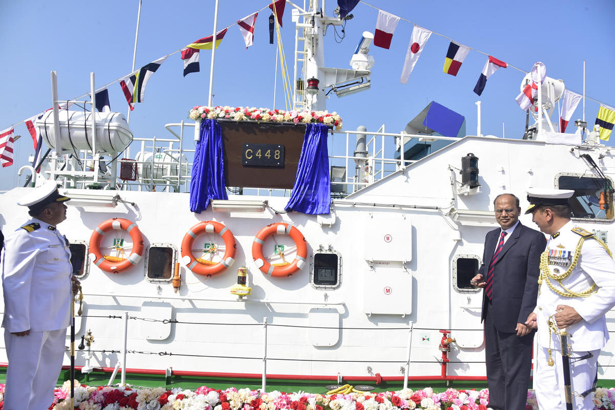 Chief Secretary T M Vijay Bhaskar unveils the plaque at the symbolic commissioning of Indian Coast Guard's Interceptor Boat C 448 at New Mangalore Port in Mangaluru on Wednesday.