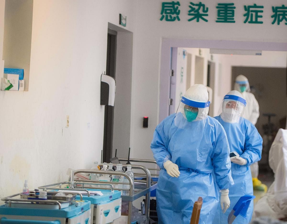 In this photo released by China's Xinhua News Agency, medical personnel wearing protective suits work in the department of infectious diseases at Wuhan Union Hospital in Wuhan in central China's Hubei Province. AP/PTI
