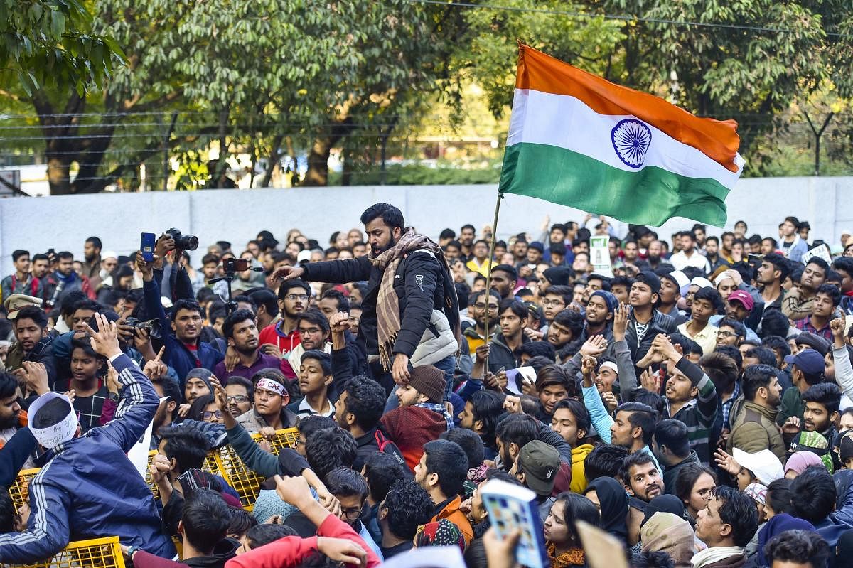 Students carry a Tricolour during their protest march against the Citizenship Amendment Act and National Register of Citizens (NRC), near Jamia Millia Islamia university in New Delhi, Thursday, Jan. 30, 2020. (PTI Photo)