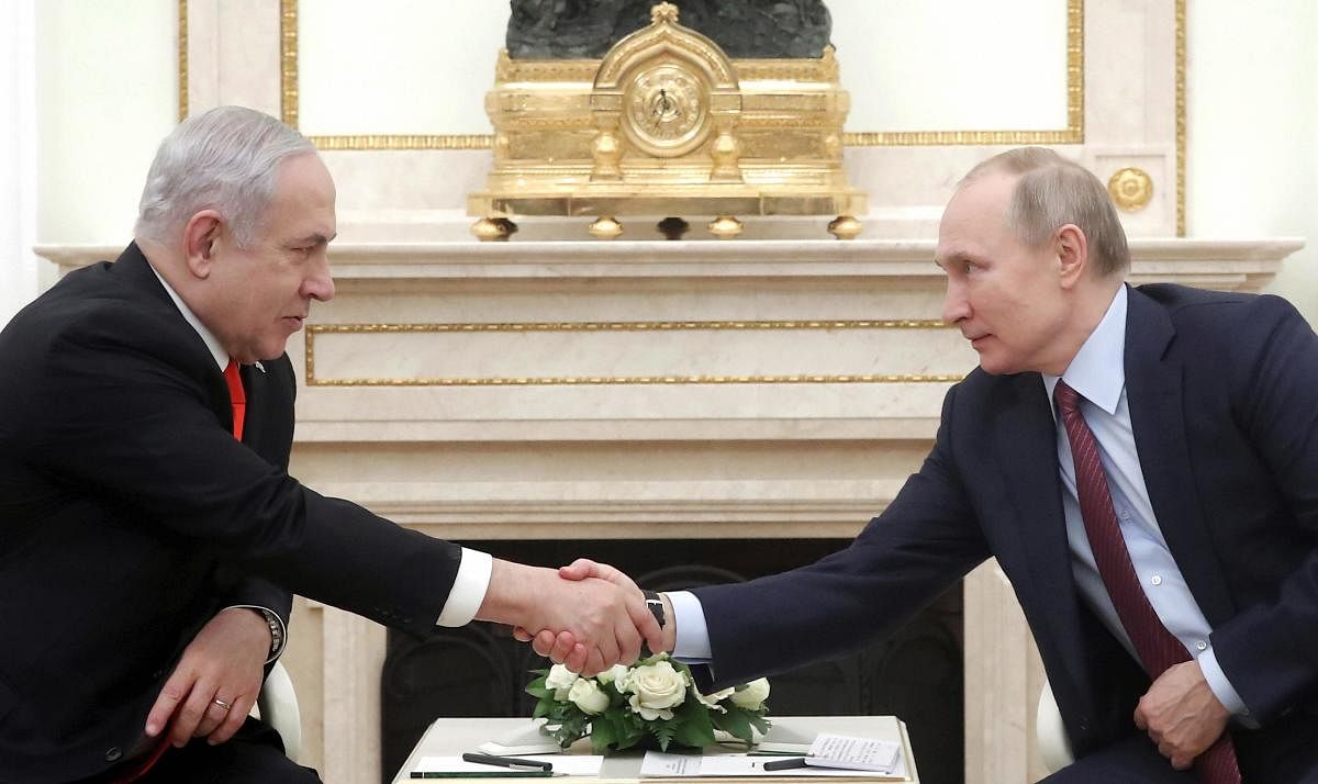 Russian President Vladimir Putin, right, shakes hands with Israeli Prime Minister Benjamin Netanyahu during their meeting in the Kremlin in Moscow. AP/PTI