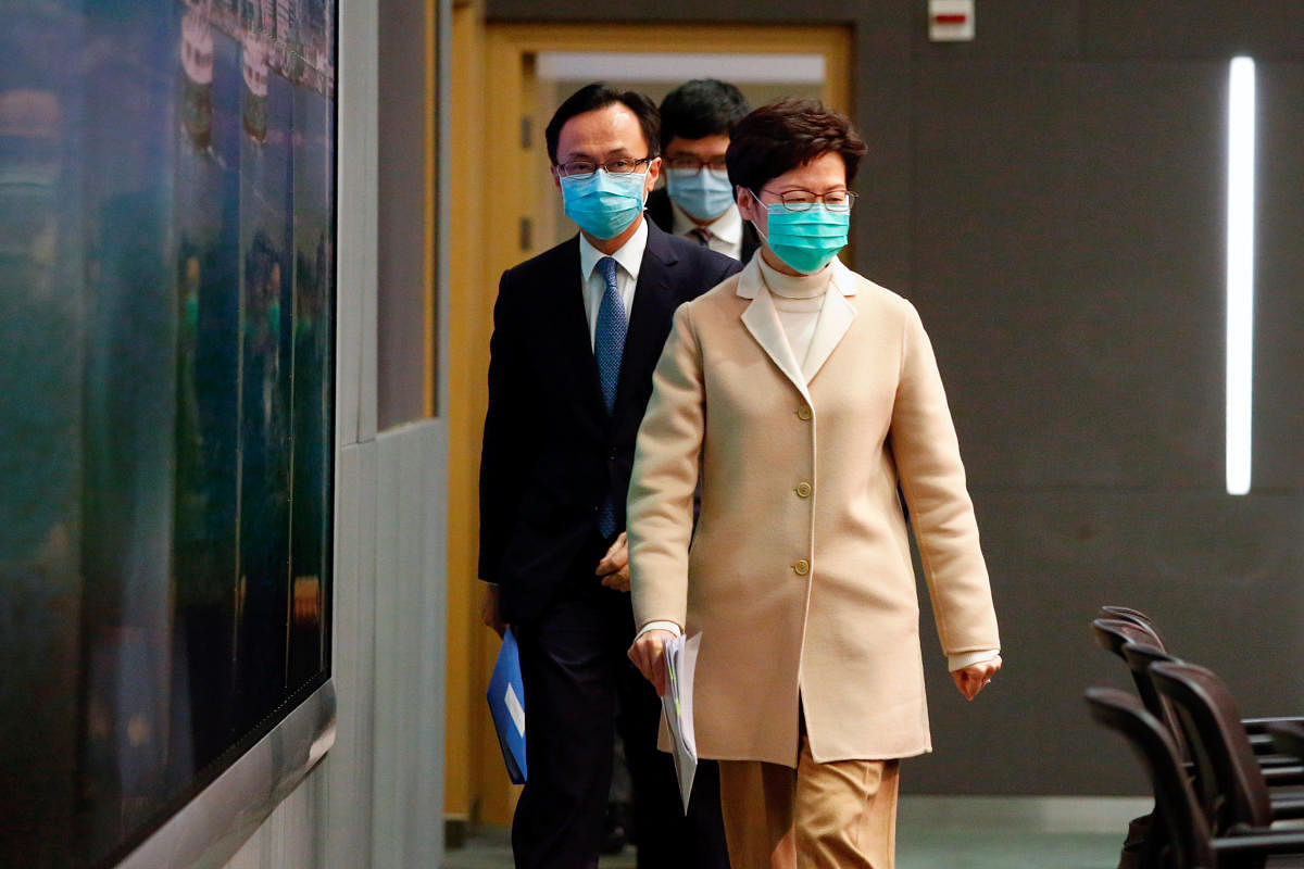 Hong Kong Chief Executive Carrie Lam wears a mask as she arrives to a news conference in Hong Kong. Reuters