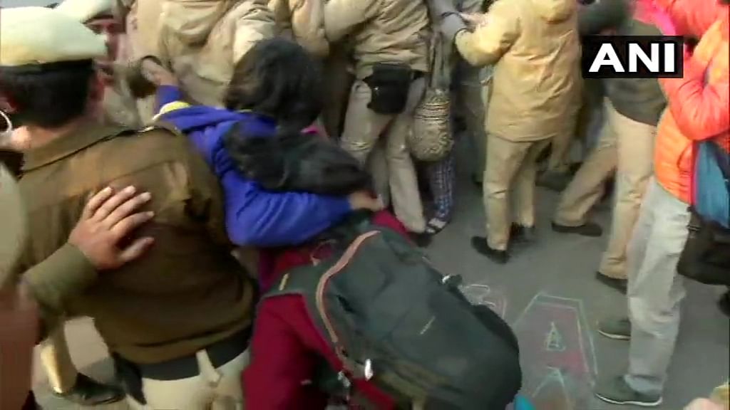 Protesters who were sitting outside Police Headquarters(old) at ITO against the firing incident in Jamia area yesterday, detained by Police. (ANI Photo)