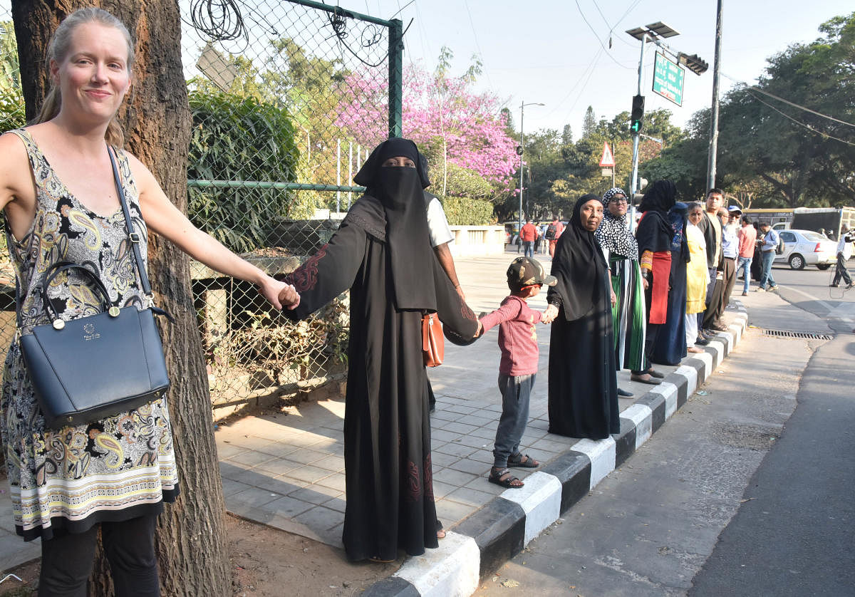 Women take part in a human chain to observe Mahatma Gandhi's death anniversary and protest against CAA, NRC and NPR on MG road in Bengaluru on Thursday, January 30, 2020. (Photo by Janardhan B K)