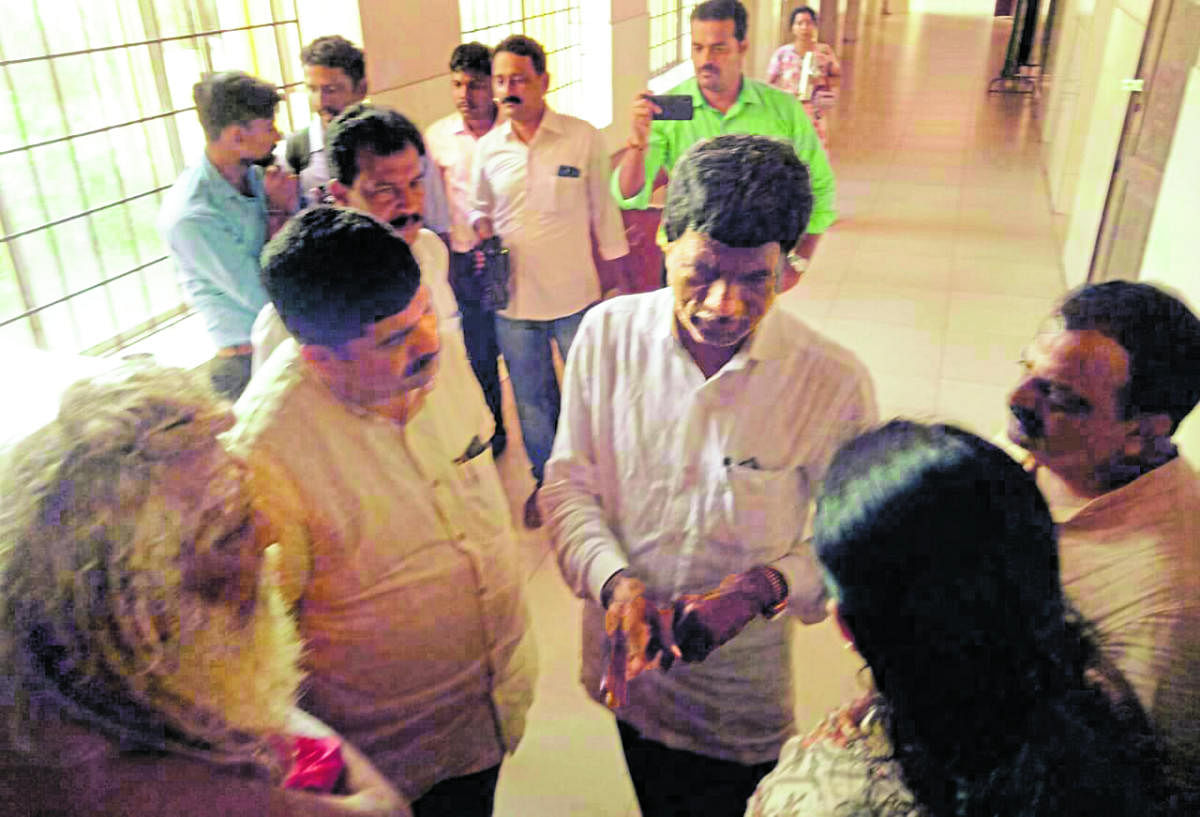 District In-charge Minister Kota Srinivas Poojary discusses acid attack victim’s rehabilitation with MLA D Vedavyas Kamath and Deputy Commissioner Sindhu B Rupesh in Mangaluru on Friday.
