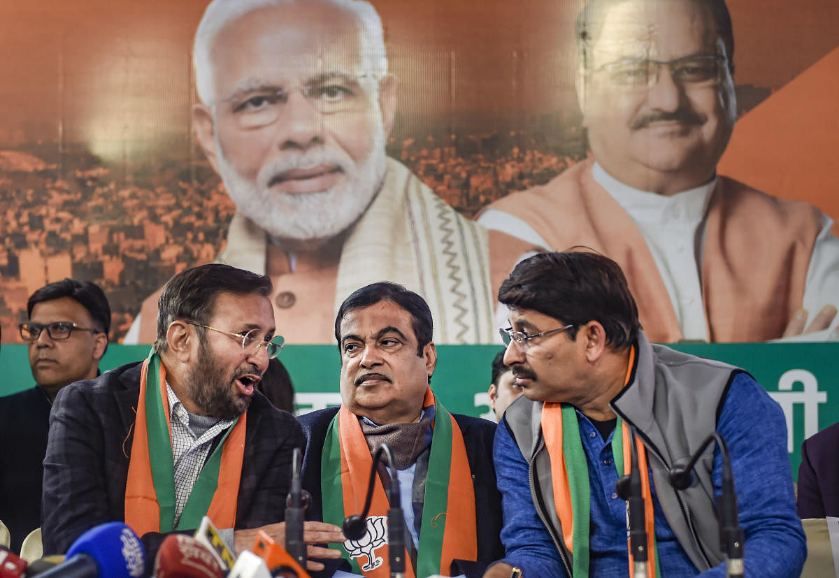 Union ministers and BJP leaders Nitin Gadkari (C) and Prakash Javadekar (L) with Delhi BJP President Manoj Tiwari at the release of the 'BJP Sankalp Patra for Delhi Assembly Elections 2020, in New Delhi, Friday, Jan. 31, 2020. (PTI Photo)