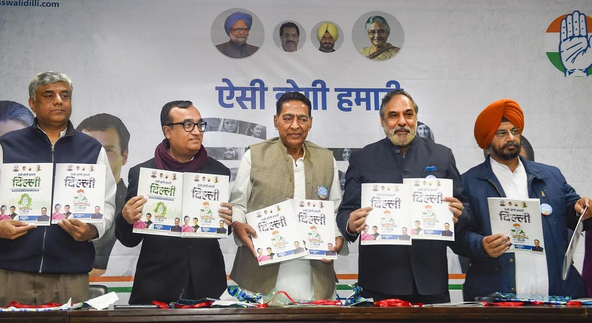 DPCC President Subhash Chopra (C) along with Congress leaders Anand Sharma, Rajeev Gowda (extreme L) Ajay Maken (2nd L) and Kuljit Singh Nagra (R) releases the Congress manifesto for the Delhi Assembly elections, at a press conference at the DPCC office