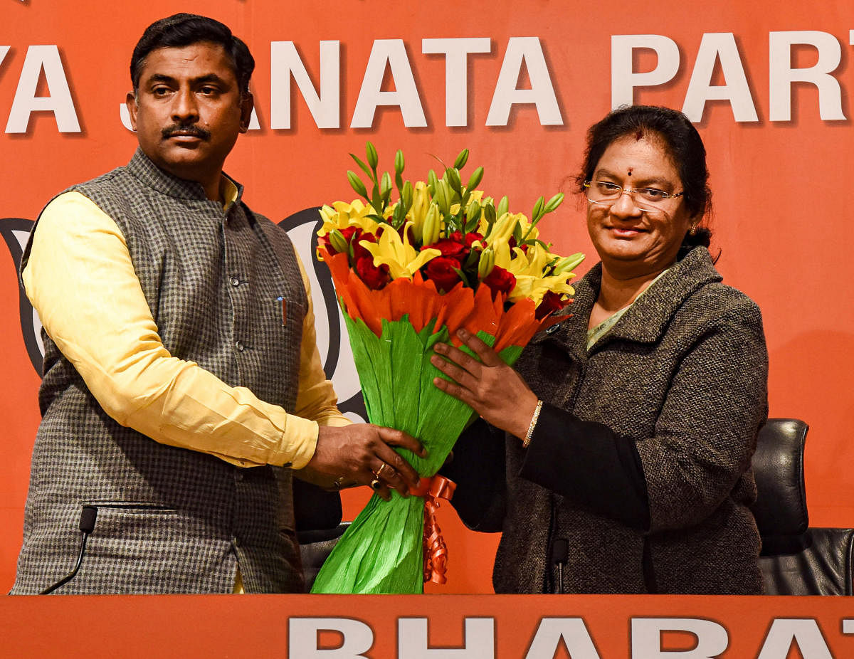 BJP general secretary P. Muralidhar Rao (L) presents a bouquet to AIADMK MP Sasikala Pushpa Ramaswamy as she joins Bharatiya Janata Party in New Delhi, Sunday, Feb. 2, 2020. Credit: PTI Photo