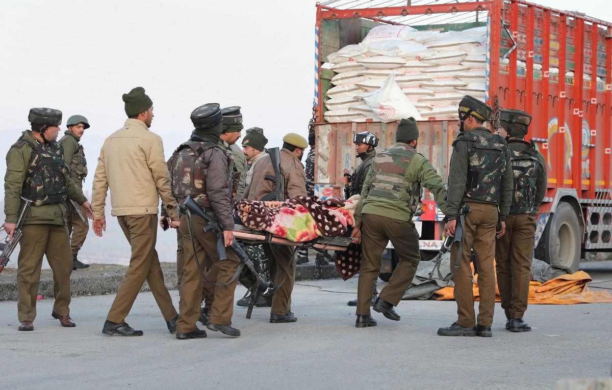  Security forces carry the body of a terrorist killed in a gunbattle (PTI Photo)