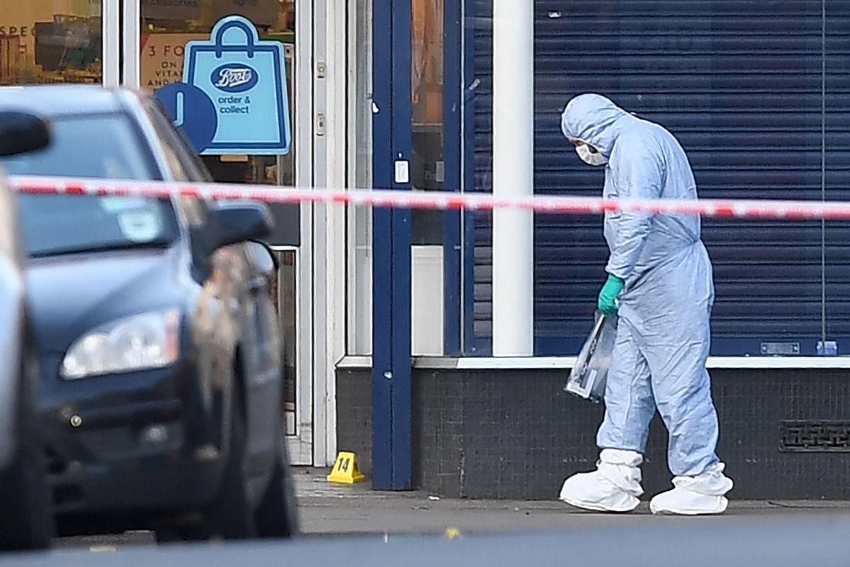 Police forensic officers work outside of a Boots store on Streatham High Road in south London on February 3, 2020, after a man was shot dead by police on February 2, following reports he had stabbed two people. AFP