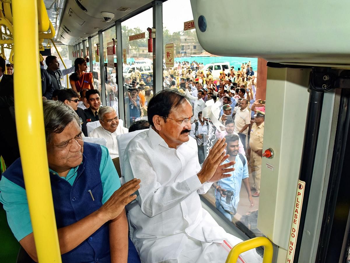 Vice President Venkaiah Naidu, Industries Minister Jagadish Shettar travel in a Chigari bus on the bus rapid transiet corridor in Hubballi on Sunday. DyCM Govind Karjol is also seen. PTI