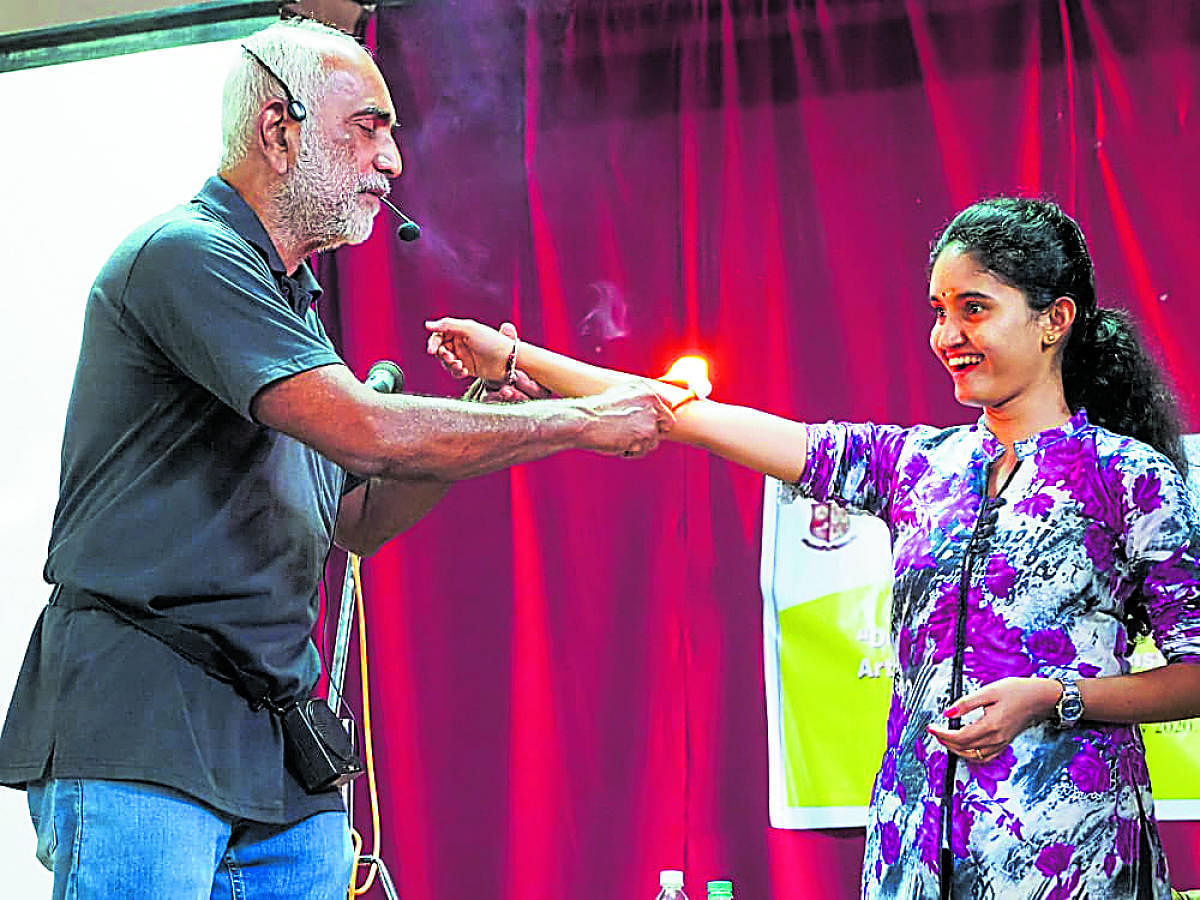 Federation of Indian Rationalist Associations (FIRA) President Prof Narendra Nayak seen demonstrating a ‘miracle’ on a student at a workshop organised by St Aloysius College recently.