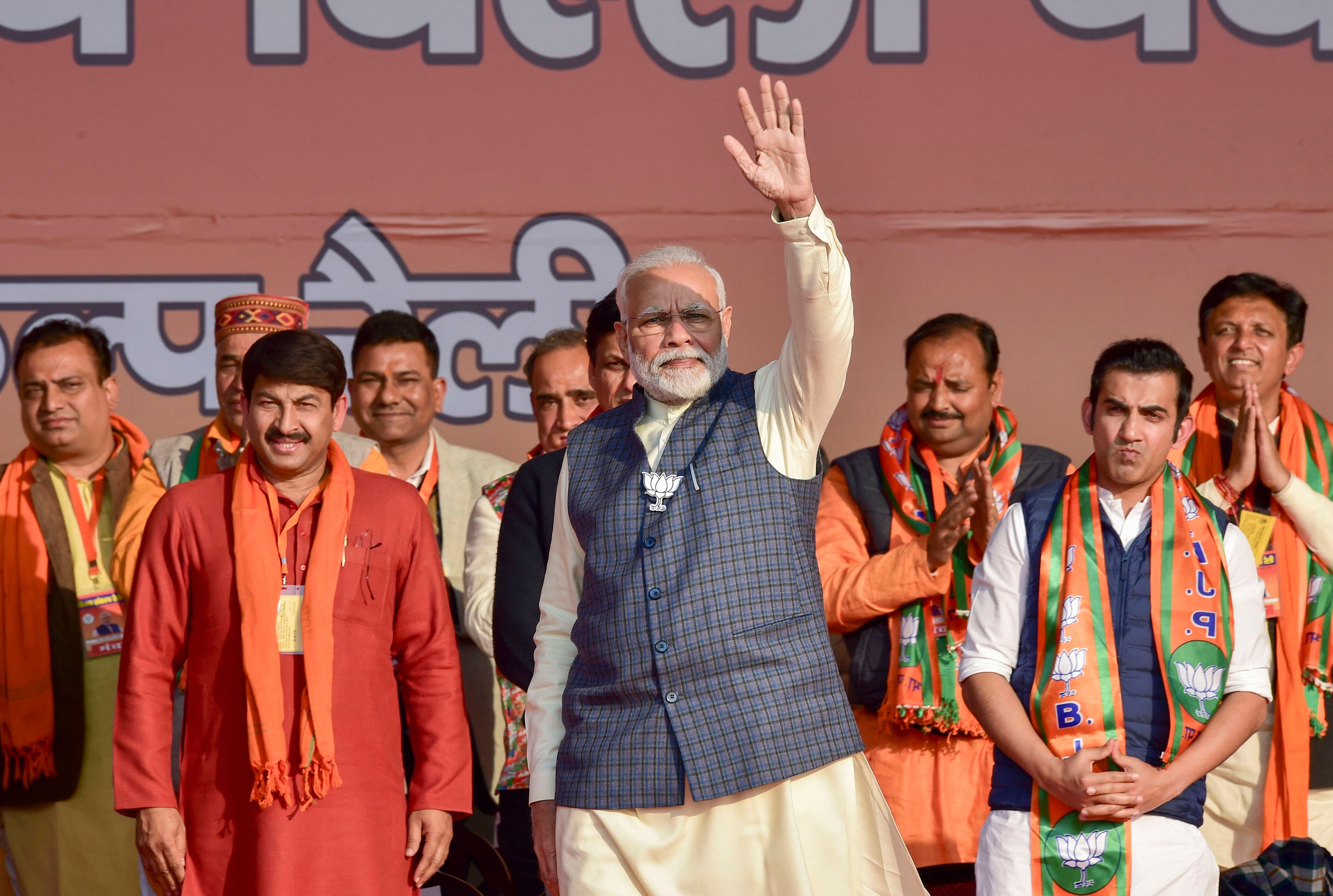 Prime Minister Narendra Modi during Vijay Sankalp Rally in support of East Delhi candidates ahead of the upcoming Delhi Assembly polls, at Karkardooma in New Delhi, Monday, Feb. 3, 2020. BJP MP Gautam Gambhir and party state president Manoj Tiwari are also seen. (PTI Photo)