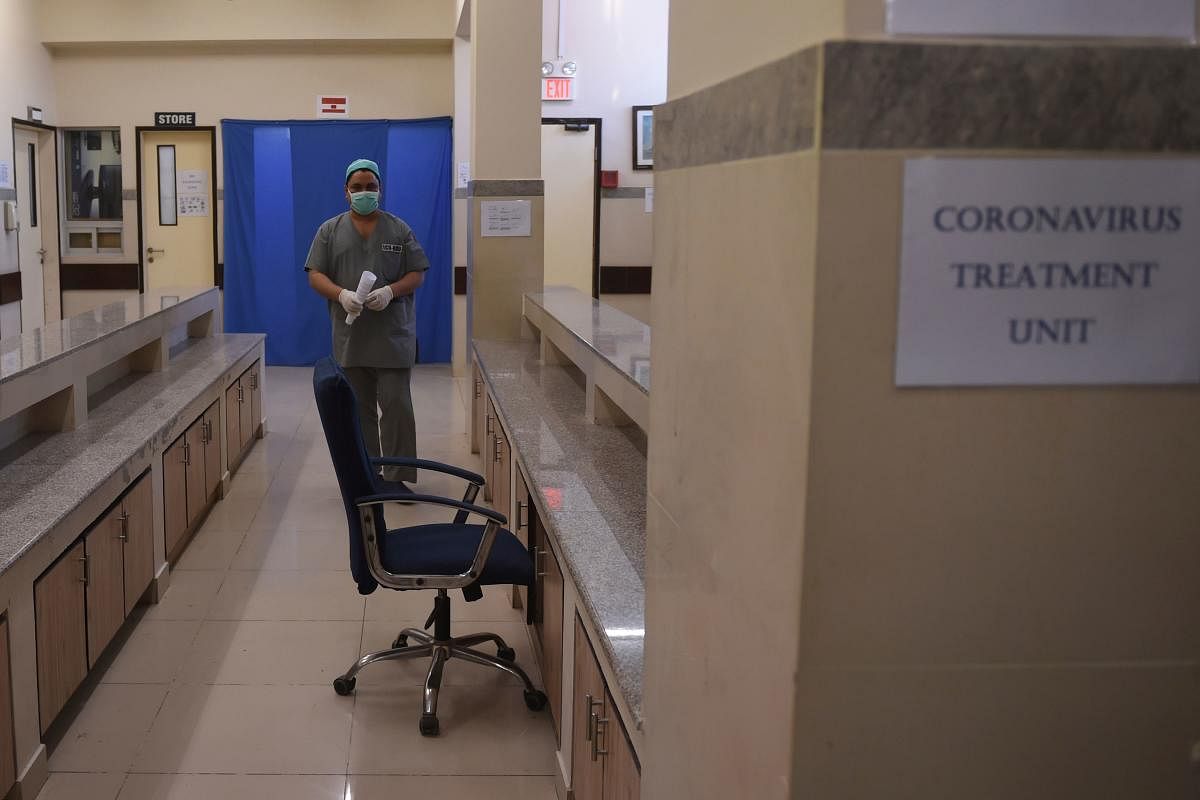 A medical staff member wearing protective facemask walks in an isolation ward set up as a preventative measure following the deadly SARS-like virus outbreak, at the Jinnah Post Graduate Medical Center (JPMC) in Karachi. AFP