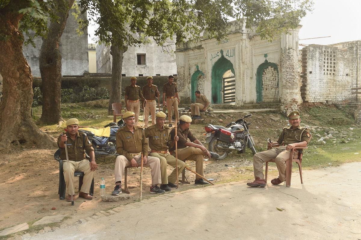 : Police personnel guard the premises near the disputed Ram Janambhoomi-Babri Masjid site. (PTI Photo)