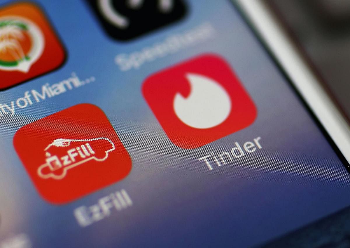 (FILES) In this file photo illustration taken on August 14, 2018, the icon for the dating app Tinder is seen on the screen of an iPhone in Miami, Florida. (Photo by JOE RAEDLE / GETTY IMAGES NORTH AMERICA / AFP)