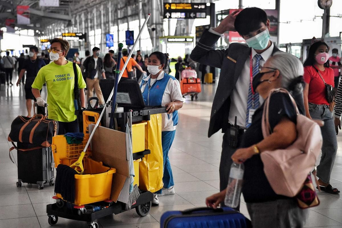 Passengers wearing protective face-masks to prevent spreading of Coronavirus (AFP Photo)