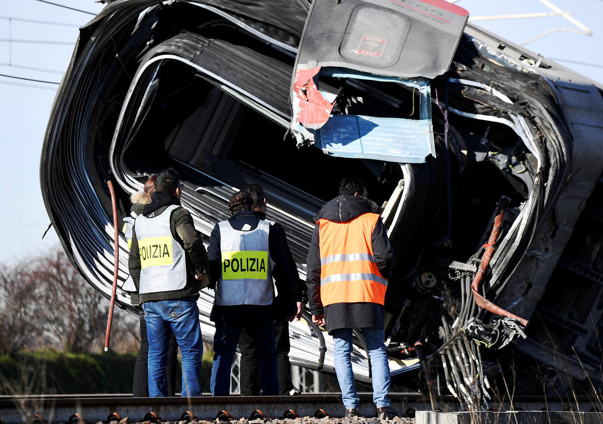 Emergency personnel work on the site of a high speed train travelling from Milan to Bologna after it derailed killing at least two people near Lodi, Italy. AFP