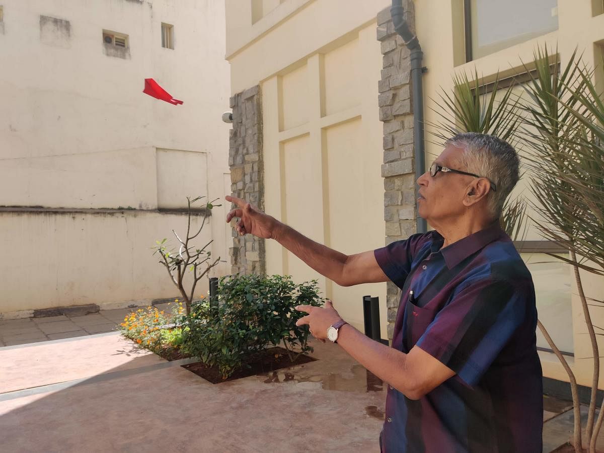 Chokkalingam flying one of his origami planes at the DH office. (DH Photo)