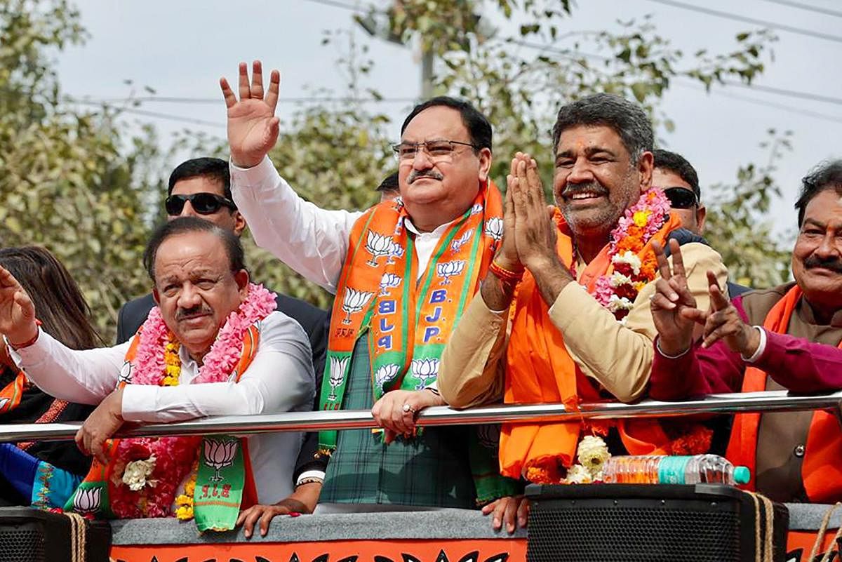BJP National President J.P. Nadda with Union minister Harsh Vardhan during an election campaign roadshow in Adarsh Nagar, ahead of Assembly polls, in New Delhi. (PTI Photo)