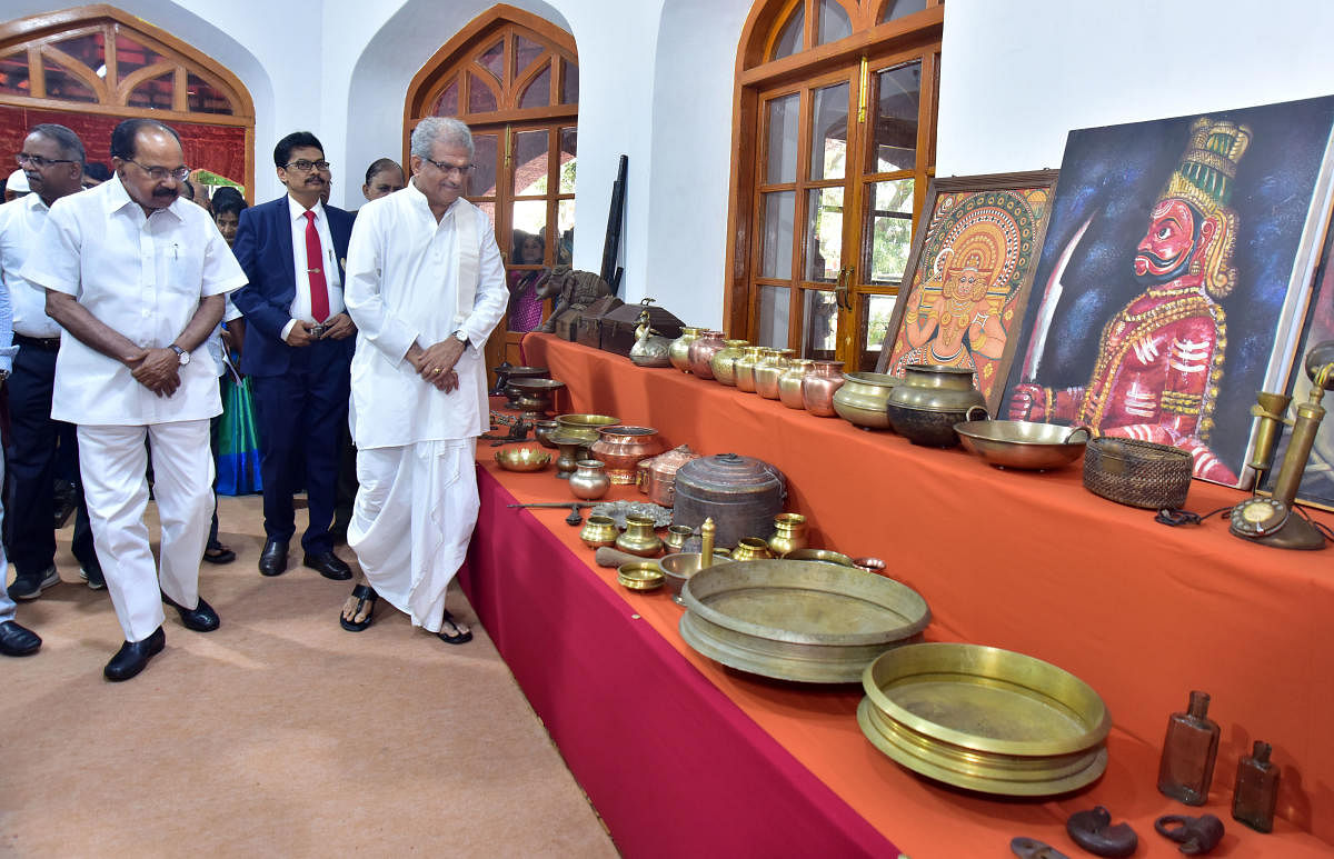 Dharamastala Dharmadhikari D Veerendra Heggade inspects household articles and artifacts of the bygone era at the 150th anniversary celebrations of University College of Mangalore University in Mangaluru on Thursday.